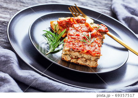 Vegan lasagna with fresh rosemary on a plate 69357517