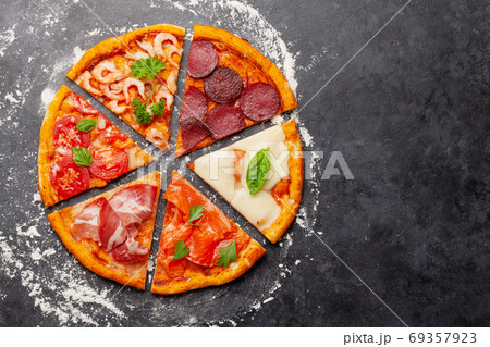 Tasty slices of different pizza Tasty slices of different pizza 69357923