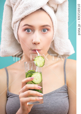 Funny cute attractive surprised white girl drinking green cocktail using a straw Funny cute attractive surprised white girl drinking green cocktail using a straw 69358910