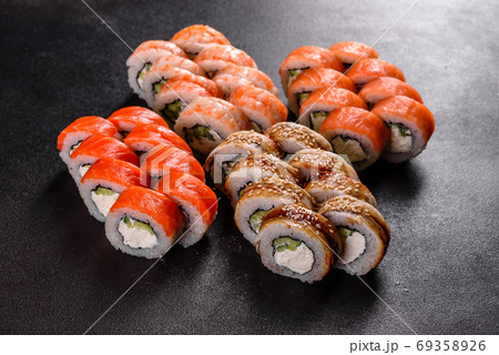 Fresh delicious beautiful sushi rolls on a dark background 69358926