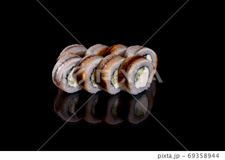 Fresh delicious beautiful sushi rolls on a dark background Fresh delicious beautiful sushi rolls on a dark background 69358944