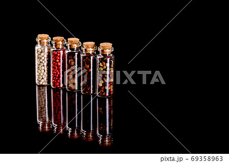 Small glass jars with corks with various spices inside Small glass jars with corks with various spices inside 69358963