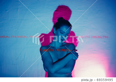 Young adult woman with word Health on her body. Young adult woman with word Health on her body. 69359495