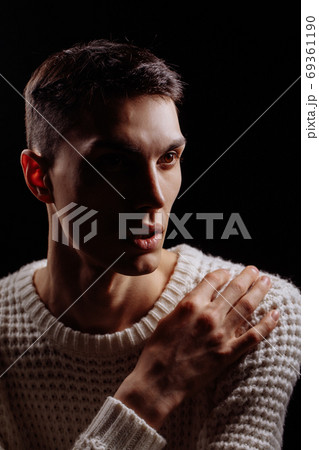 Studio shot of a handsome young male model wearing white T-shirt and sunglasses Studio shot of a handsome young male model wearing white T-shirt and sunglasses 69361190