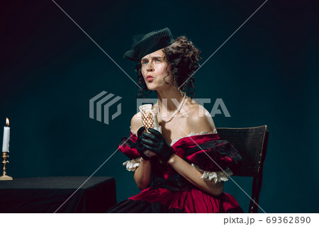 Young woman as Anna Karenina on dark blue background. Retro style, comparison of eras concept. 69362890