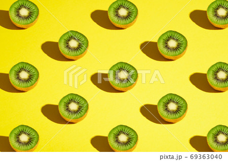 Kiwi fruits pattern on yellow background Kiwi fruits pattern on yellow background 69363040
