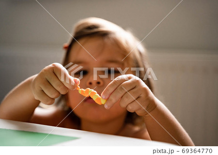Caucasian toddler girl playing modeling play dough at home with mother. Homeschooling concept Caucasian toddler girl playing modeling play dough at home with mother. Homeschooling concept 69364770