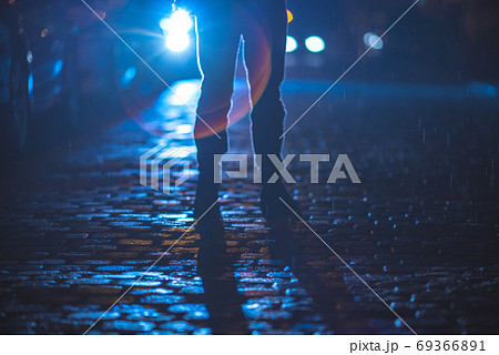 The man stand on the stone road. Evening night time. Telephoto lens shot 69366891