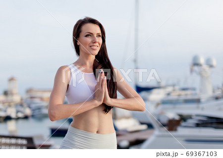 Woman working out outdoors, doing yoga exercise, Tree Pose at Navy Pier 69367103