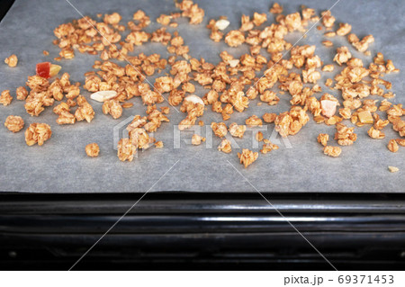 Close-up muesli on parchment paper on baking sheet. Made homemad 69371453