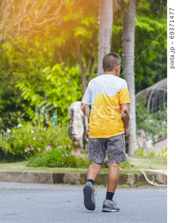 Back view portrait of a Asian elderly man in fitness wear walking and jogging for good health in public park. Senior jogger in nature. Older Man enjoying Peaceful nature. Healthcare concept. Back view portrait of a Asian elderly man in fitness wear walking and jogging for good health in public park. Senior jogger in nature. Older Man enjoying Peaceful nature. Healthcare concept. 69371477
