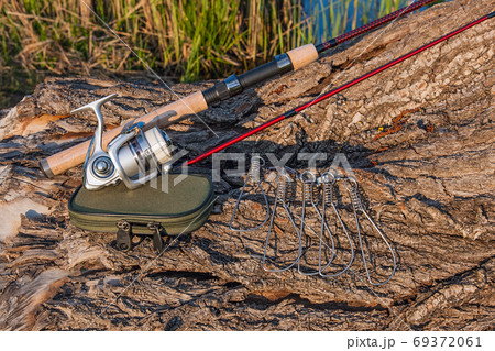 Fishing rod and reel on the natural background. Fish stringer an Fishing rod and reel on the natural background. Fish stringer an 69372061