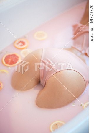 Perfect female buttocks close up in lace panties in milky bathtube with oranges Perfect female buttocks close up in lace panties in milky bathtube with oranges 69373320