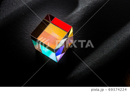 Colorful bright glass prism cube  Refracting light in vivid rain 69374224