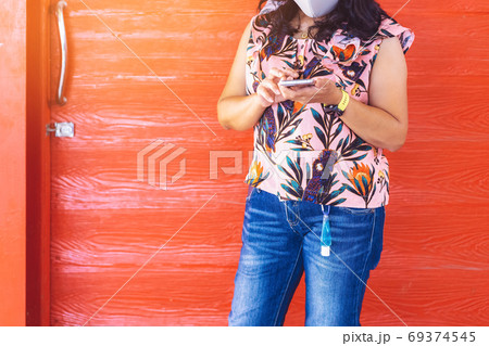 Mini portable alcohol gel bottle to kill Corona Virus(Covid-19) hanging on belt loop of woman' s jeans with plank background. New normal lifestyle. Health care concept. Selective focus on alcohol gel Mini portable alcohol gel bottle to kill Corona Virus(Covid-19) hanging on belt loop of woman' s jeans with plank background. New normal lifestyle. Health care concept. Selective focus on alcohol gel 69374545
