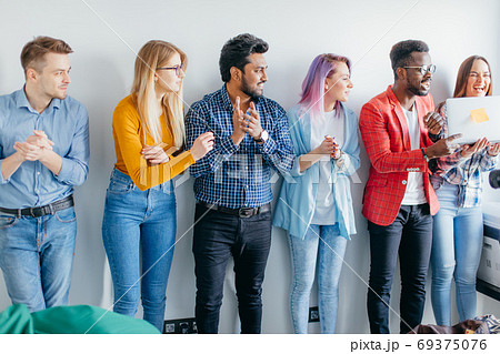 Multiethnic Group of Young People in Casual Wear isolated over grey background 69375076