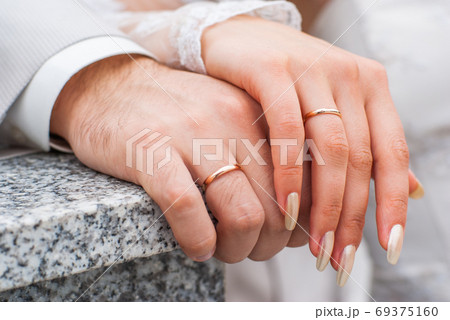 Just married couple showing up their rings 69375160