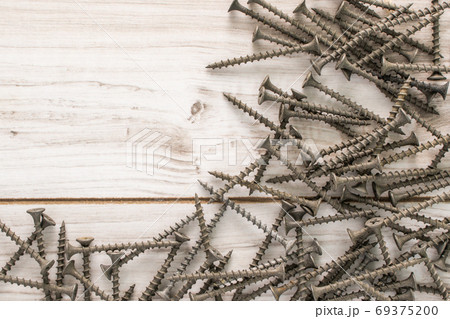 Group of Screw bolts on wooden background. Group of Screw bolts on wooden background. 69375200