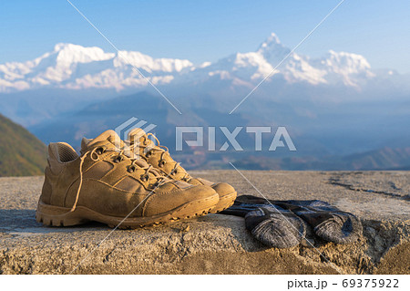 Tourist Hiking Boots With Socks, Mountains on Background 69375922