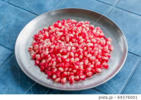 Pomegranate grains on a plate, stock photo 69376001