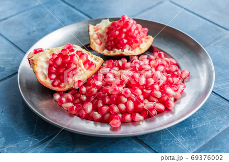 Pomegranate grains on a plate, stock photo Pomegranate grains on a plate, stock photo 69376002