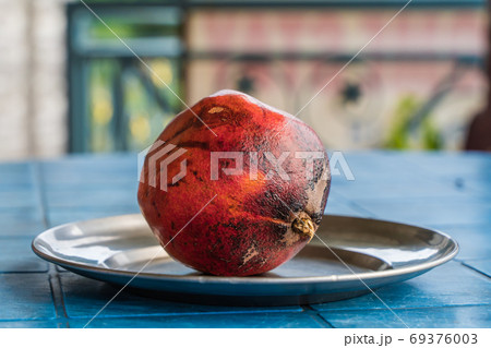 One Pomegranate on a Plate, Stock Photo One Pomegranate on a Plate, Stock Photo 69376003