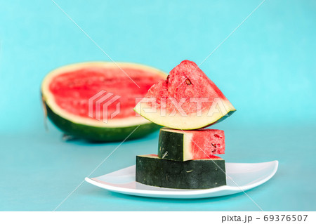 Water melon slices on a plate on blue background 69376507