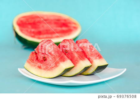 Water melon slices on a plate on blue background 69376508