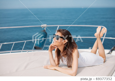 Young sexy woman on her private yacht at sunset 69377352