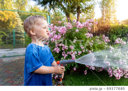 Cute adorable caucasian blond toddler boy enjoy 69377680