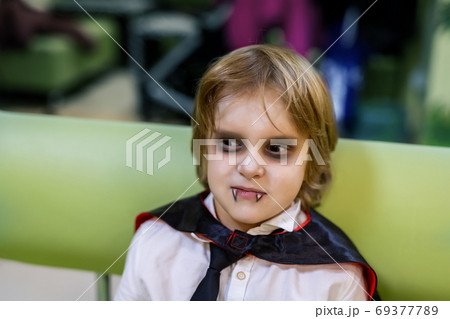 Cute adorable caucasian kid boy in dracula vampire Cute adorable caucasian kid boy in dracula vampire 69377789