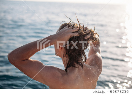 Young caucasian hipster guy enjoying journey on yacht deck sailing the sea. 69378256