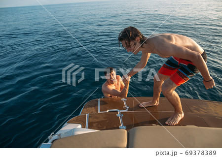 Two happy friends traveling on a yacht. Vacation, tourism, holiday, concept. 69378389