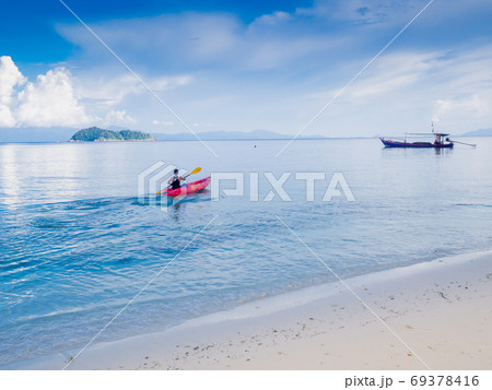 Man padding red kayak in blue sea at beauty day light, Travel plans in holidays or after retirement 69378416