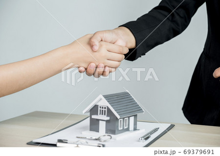 hands shaking after Real estate agents explains a business contract hands shaking after Real estate agents explains a business contract 69379691