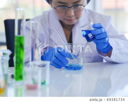 Senior scientists are mixing 2 types of solutions Senior scientists are mixing 2 types of solutions 69381734