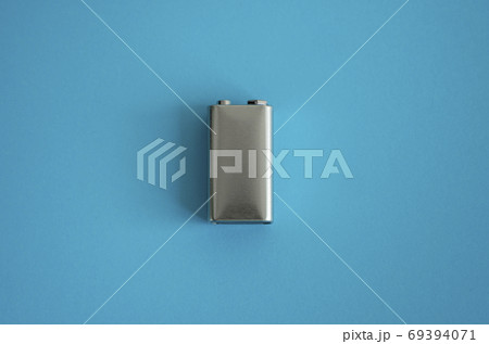 High voltage battery on a blue background. Silver Volt battery. 9V Advanced Lithium Batteries. High voltage battery on a blue background. Silver Volt battery. 9V Advanced Lithium Batteries. 69394071