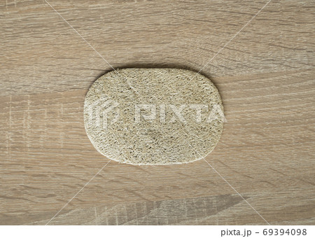 Natural loofah kitchen dish washing sponges. Eco friendly dishwashing sponge on a table, top view. Biodegradable dishwashing scrub pad. Natural loofah kitchen dish washing sponges. Eco friendly dishwashing sponge on a table, top view. Biodegradable dishwashing scrub pad. 69394098