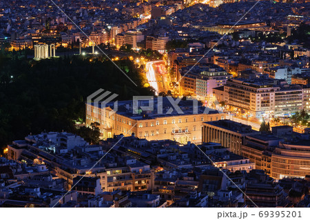 Night view Hellenic Parliament in Syntagma square brightly lit up and ruins of temple of Olympian Zeus behind it shot from hill of Lycabettus, Night view Hellenic Parliament in Syntagma square brightly lit up and ruins of temple of Olympian Zeus behind it shot from hill of Lycabettus, 69395201