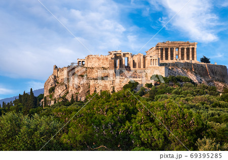 Great view of Acropolis hill from Pnyx hill on summer day with great clouds in blue sky, Athens, Greece. UNESCO world heritage. Propylaea, Parthenon. 69395285