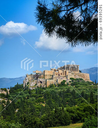 Great view of Acropolis hill from Pnyx hill on summer day with great clouds in blue sky, Athens, Greece. UNESCO world heritage. Propylaea, Parthenon. 69395291