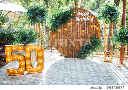 Round wooden arch, photo zone for a photo shoot for a 50th anniversary man Round wooden arch, photo zone for a photo shoot for a 50th anniversary man 69396925