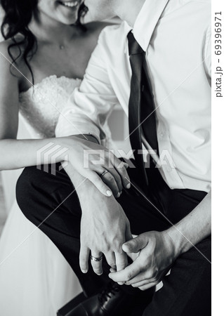 close-up portrait of the bride and groom. They hug their arms. Wedding rings on their hands close-up portrait of the bride and groom. They hug their arms. Wedding rings on their hands 69396971