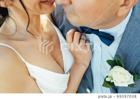 Close-up portrait of a bride and groom standing on the city street and lovely hugging 69397038
