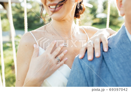 Close-up portrait of a bride and groom standing on the city street and lovely hugging 69397042