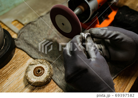 close-up. The jeweler makes a silver ring close-up. The jeweler makes a silver ring 69397582