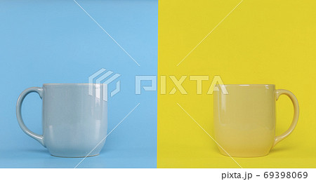 Blue cup on blue background and yellow cup on yellow background Blue cup on blue background and yellow cup on yellow background 69398069