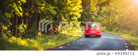 red car on asphalt road in summer red car on asphalt road in summer 69399211