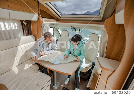 Couples in RV Camper looking at the local map 69402020