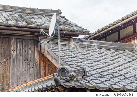 Satellite dish on old traditional houses. Kumagawa, a small village on the historic trading route from Kyoto to Fukui, Japan. Satellite dish on old traditional houses. Kumagawa, a small village on the historic trading route from Kyoto to Fukui, Japan. 69403062